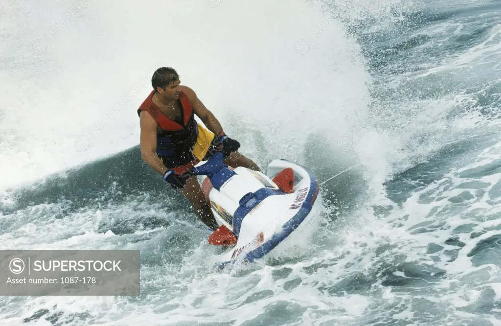 High angle view of a young man riding a jet ski