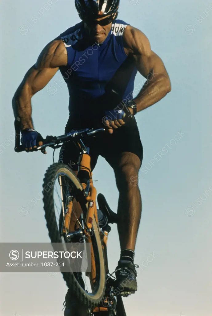 Low angle view of a young man mountain biking