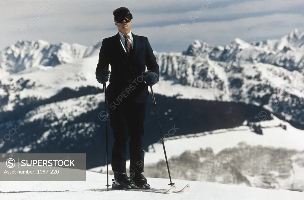 Close-up of a businessman holding ski poles
