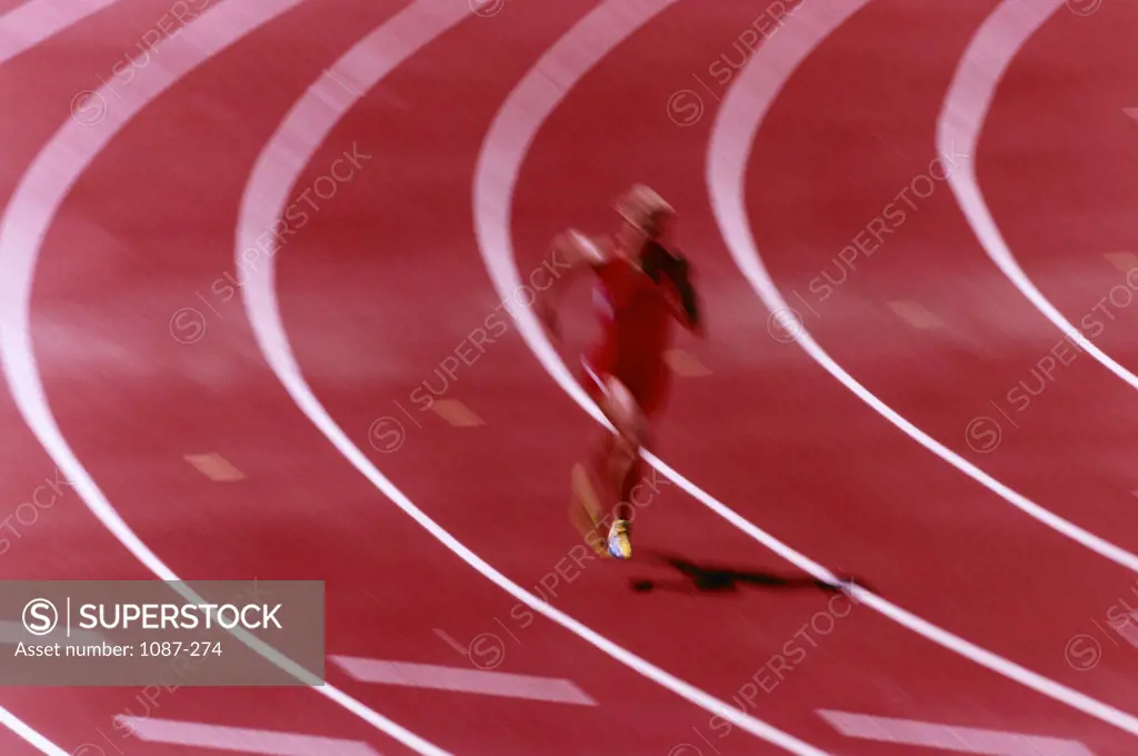 High angle view of a woman running on a track