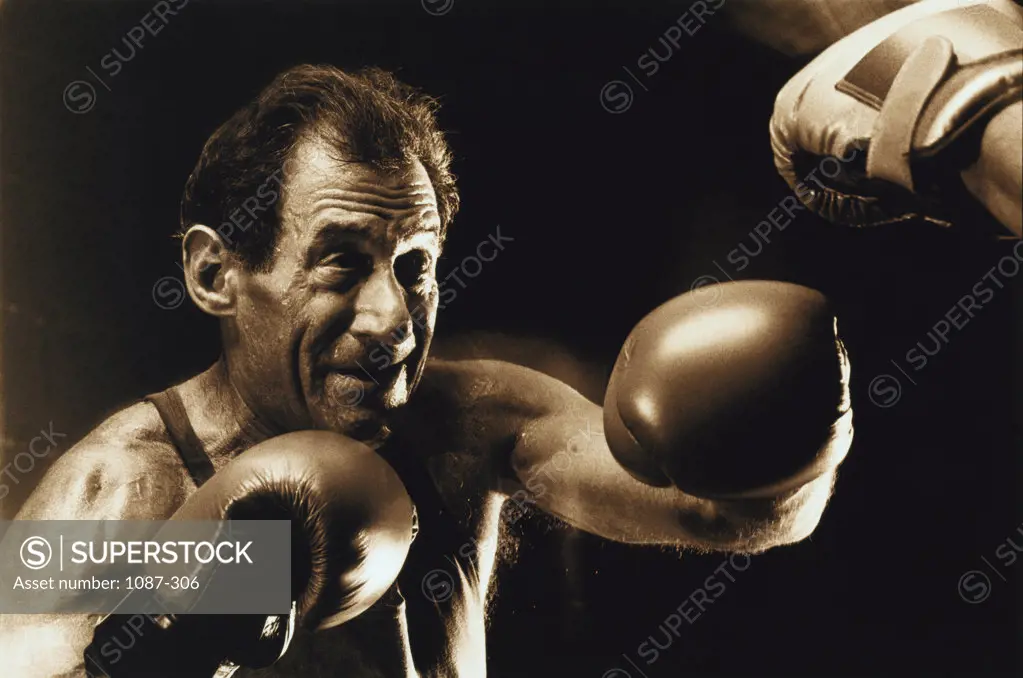 Senior man punching his opponent