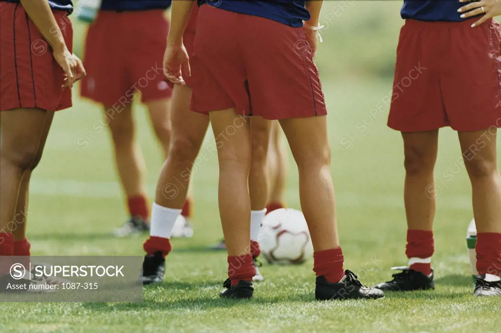 Soccer players standing in a soccer field