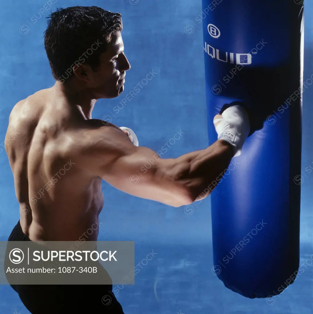 Close-up of a boxer punching a punching bag