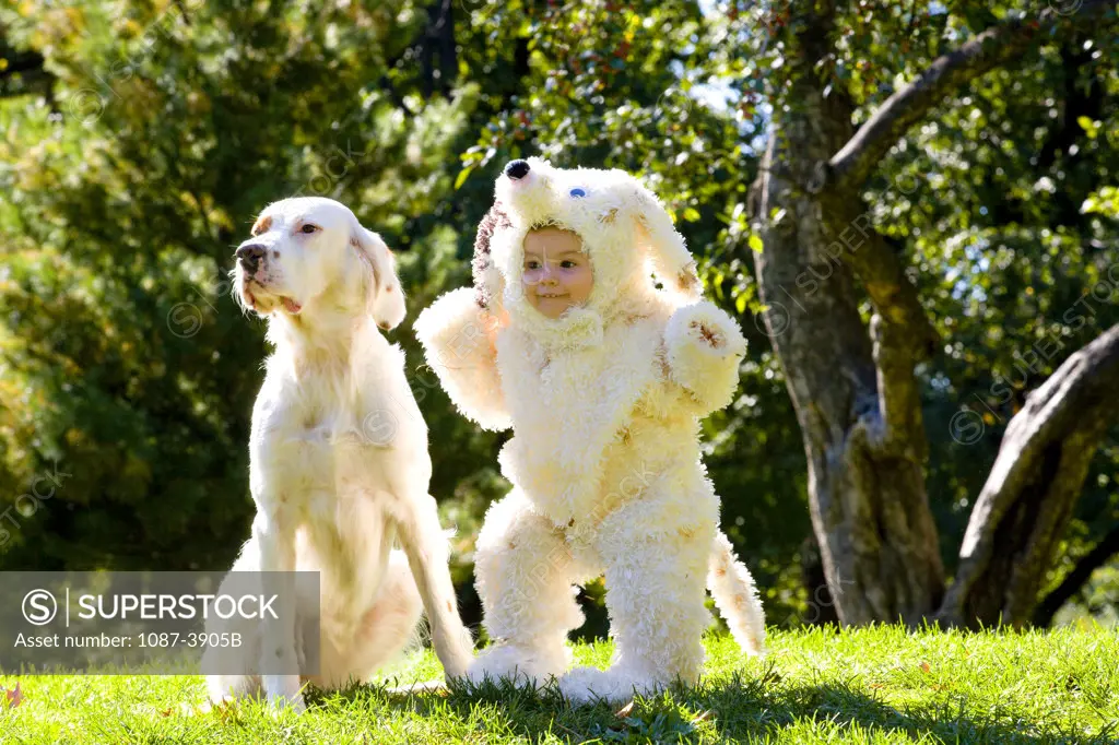 Girl wearing a dog costume and playing with a dog