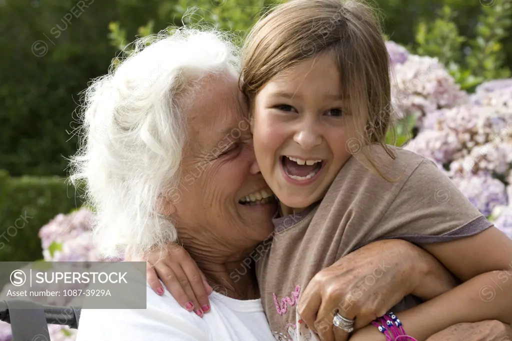 Senior woman hugging her granddaughter
