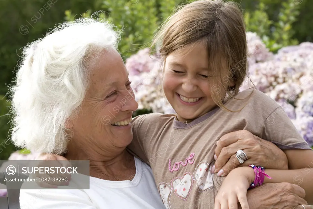 Senior woman hugging her granddaughter