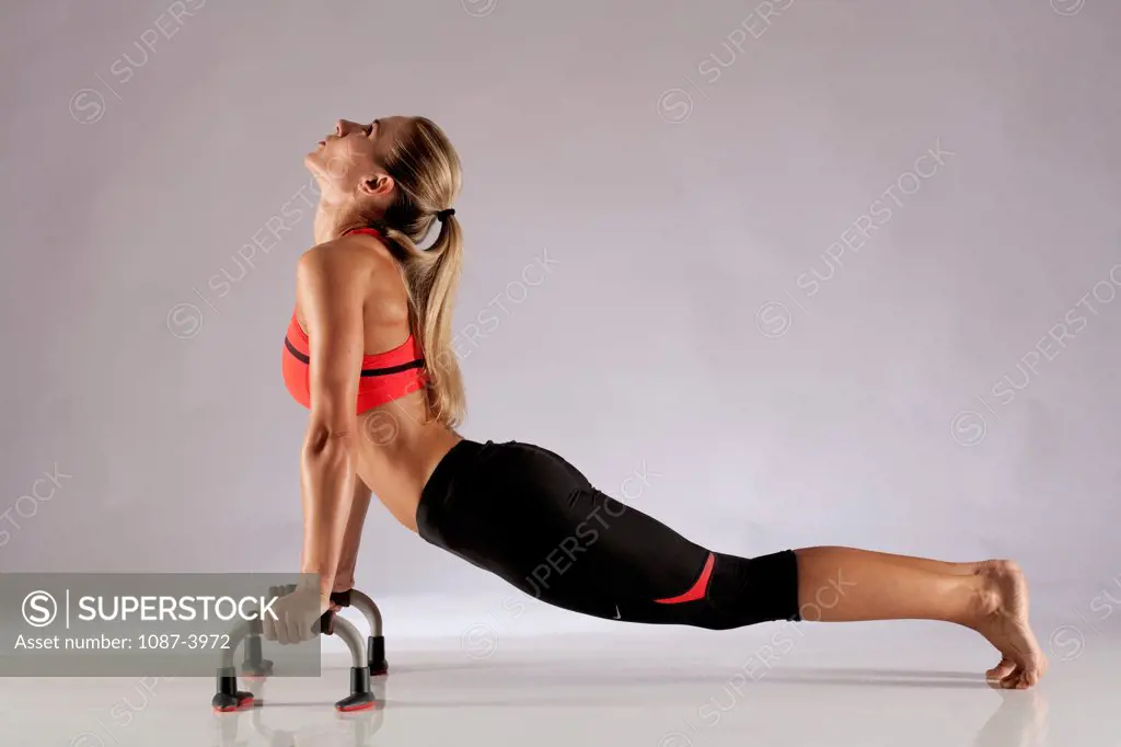 Studio shot of exercising woman