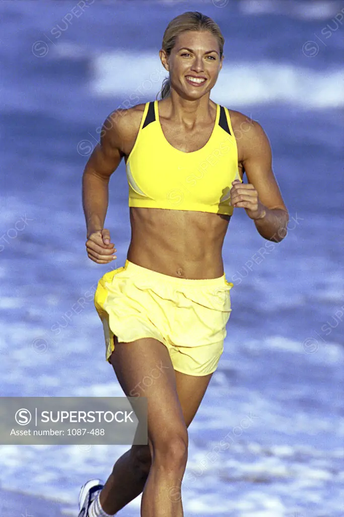 Portrait of a young woman jogging on the beach