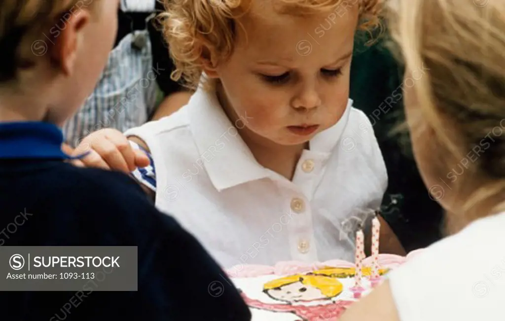 Close-up of a girl blowing out candles