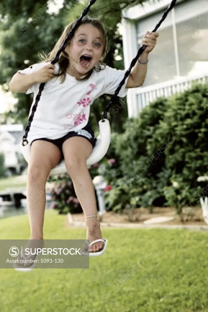 Low angle view of a girl swinging on a swing