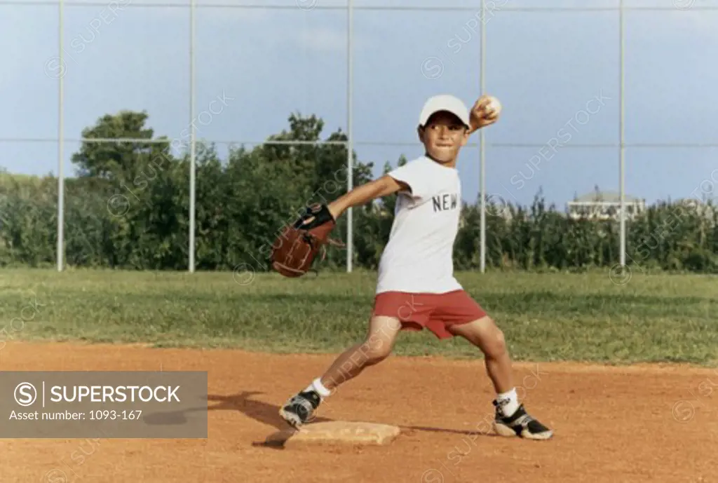 Boy throwing a ball in a baseball field