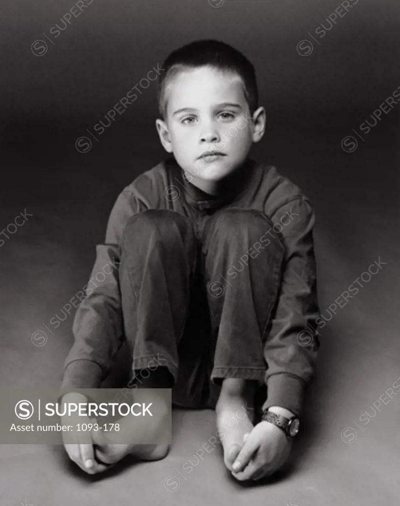 Portrait of a boy sitting on a floor