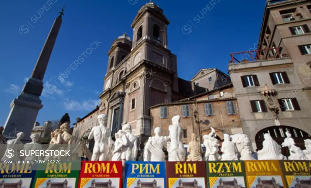 Low angle view of an obelisk with statues in front of a church, Trinita dei Monti, Rome, Italy