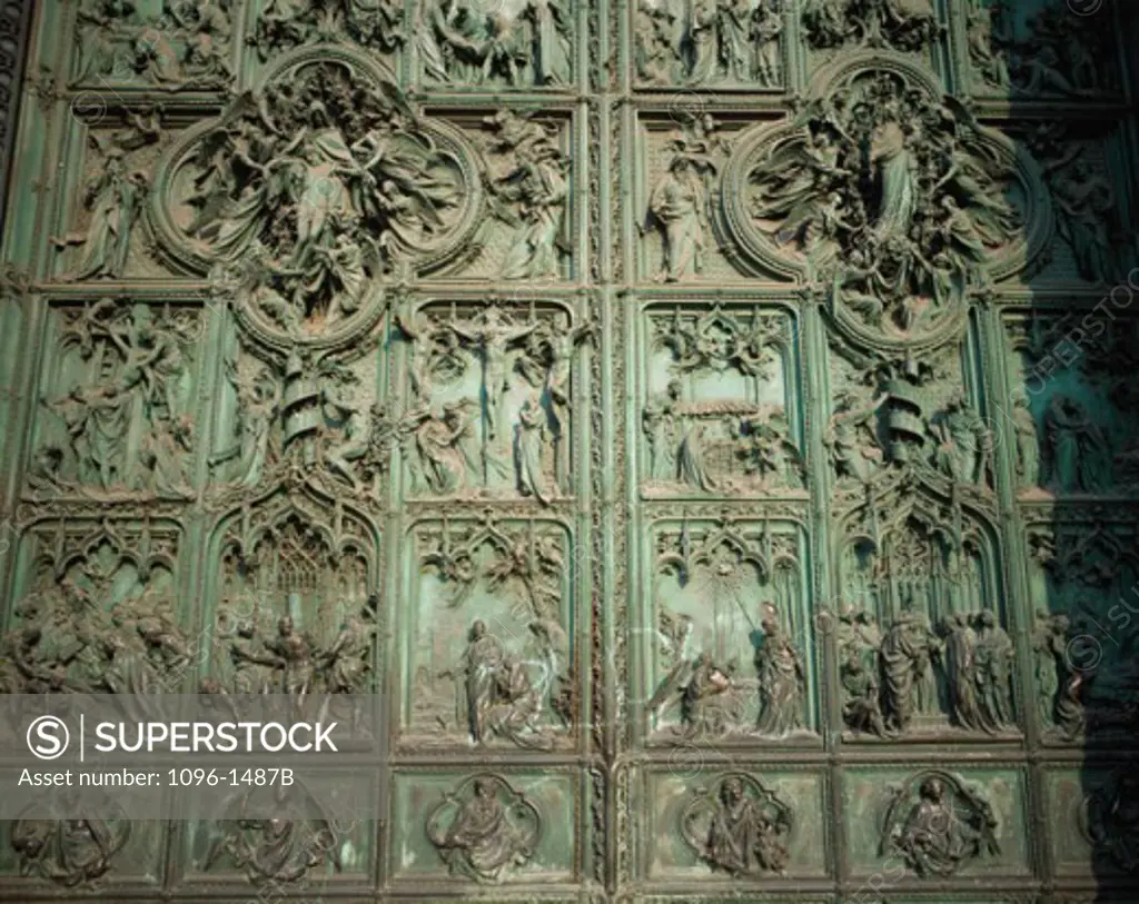 Close-up of sculptures carved on a door, Bronze Door, Duomo di Milano, Milan, Italy