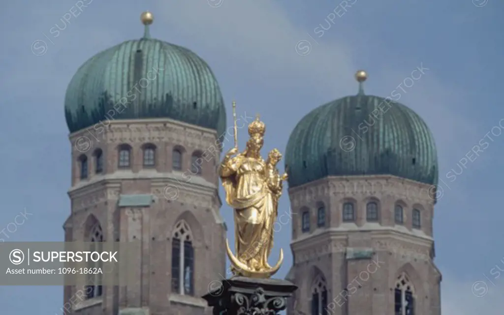 Low angle view of a statue in front of a cathedral, Frauenkirche, Munich, Germany