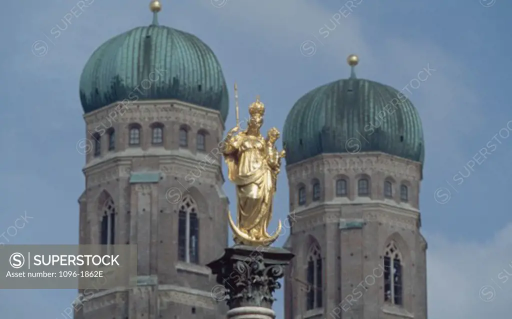Low angle view of a statue in front of a cathedral, Frauenkirche, Munich, Germany
