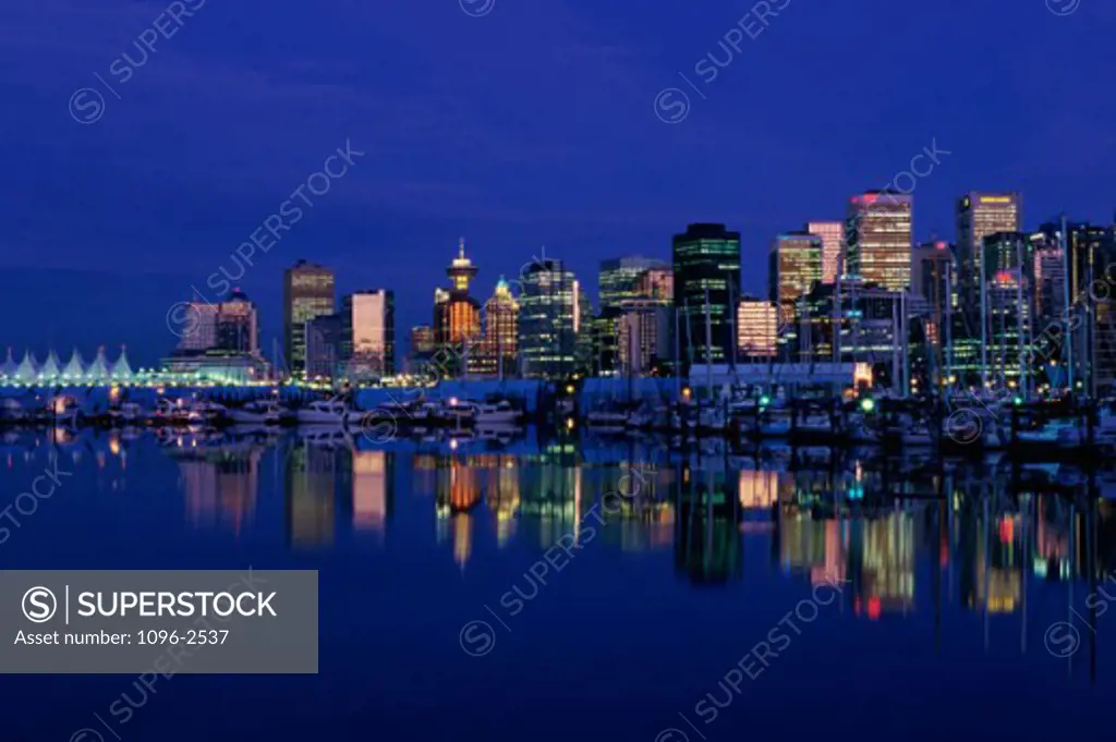 Buildings in a city lit up at night, Vancouver, British Columbia, Canada