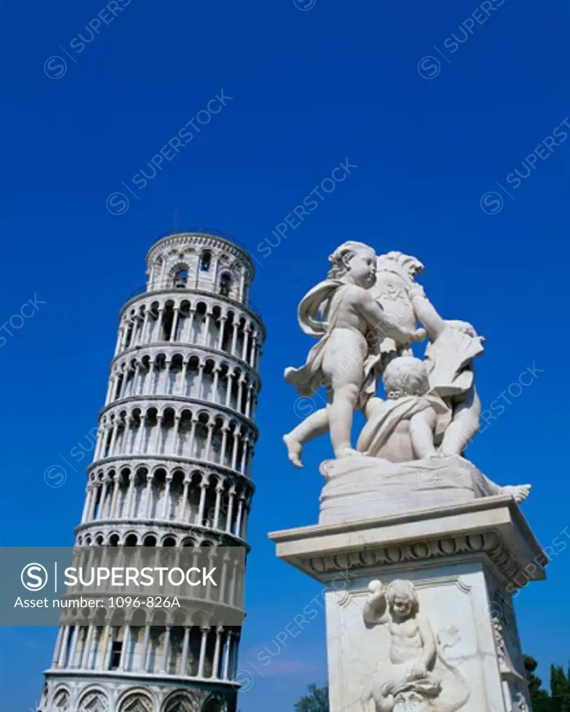 A Statue with the Leaning Tower of Pisa in the background, Italy