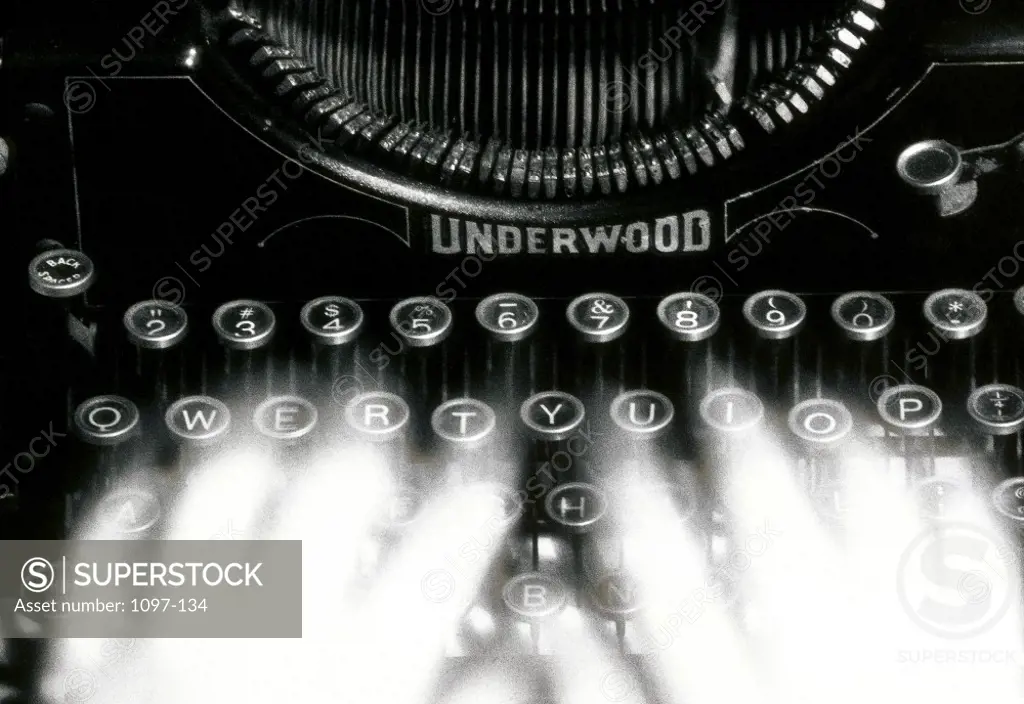 Close-up of a person's hands typing on a typewriter