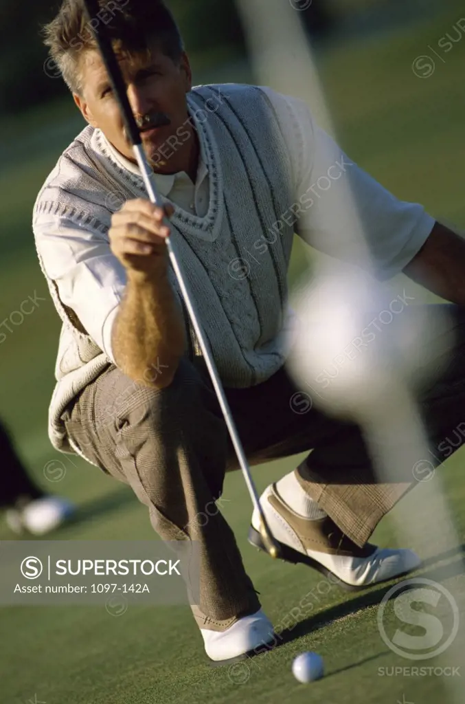 Mid adult man holding a golf club
