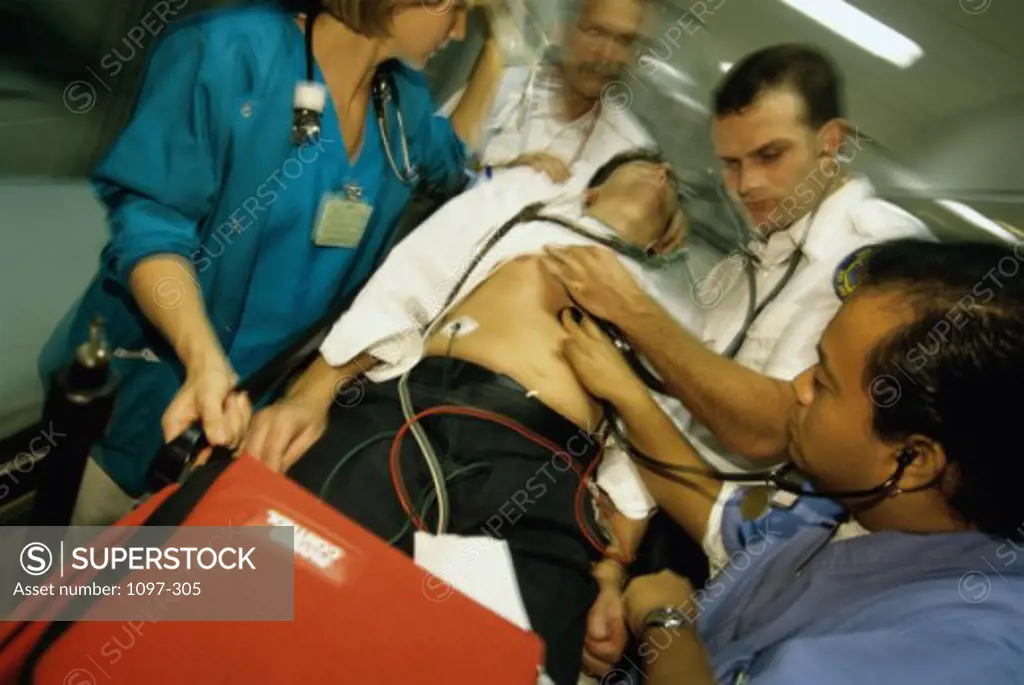 Paramedics pushing a man on a stretcher