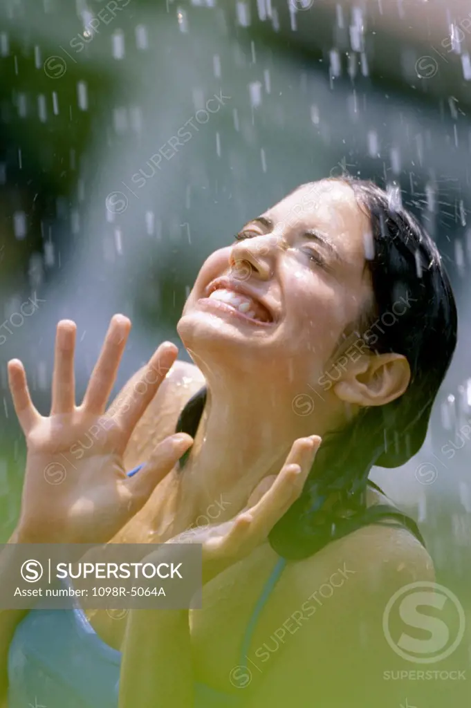 Teenage girl standing in the rain