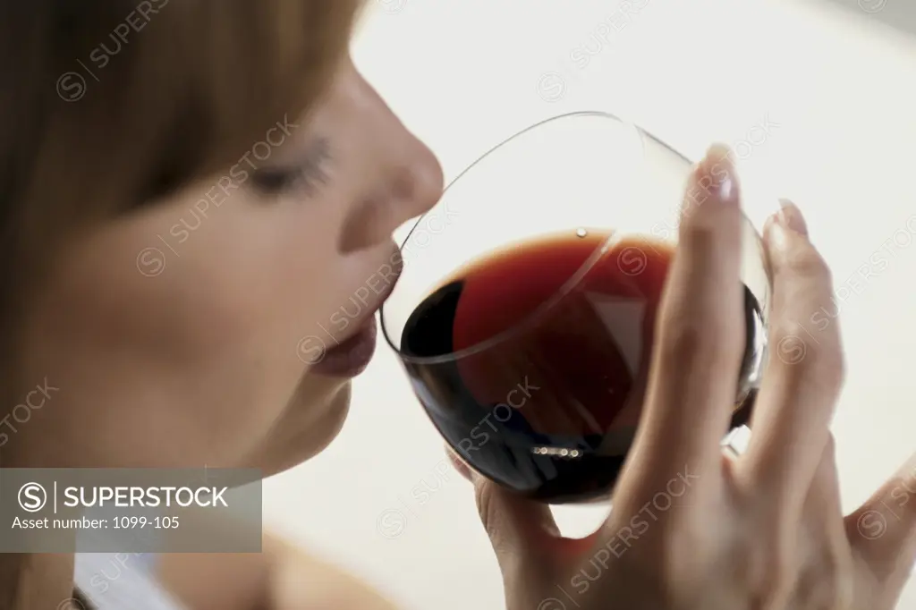 Close-up of a young woman drinking red wine