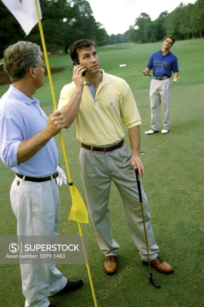 Three men on a golf course