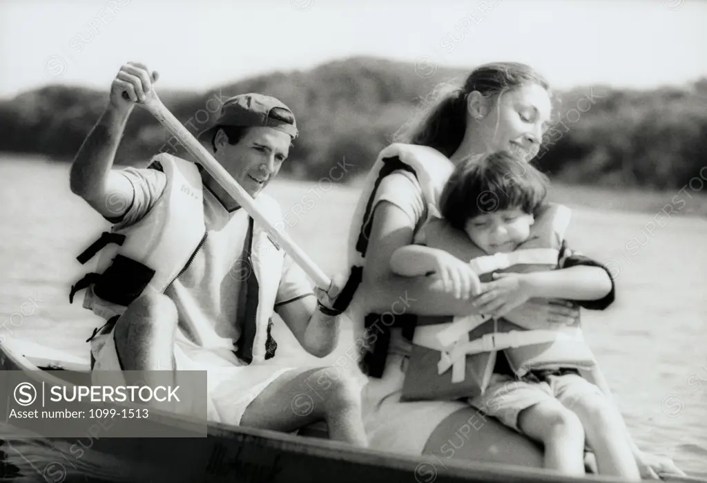 Parents in a boat with their daughter