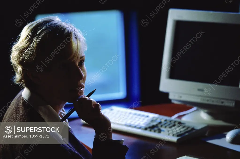 Side profile of a businesswoman with her hand on her chin