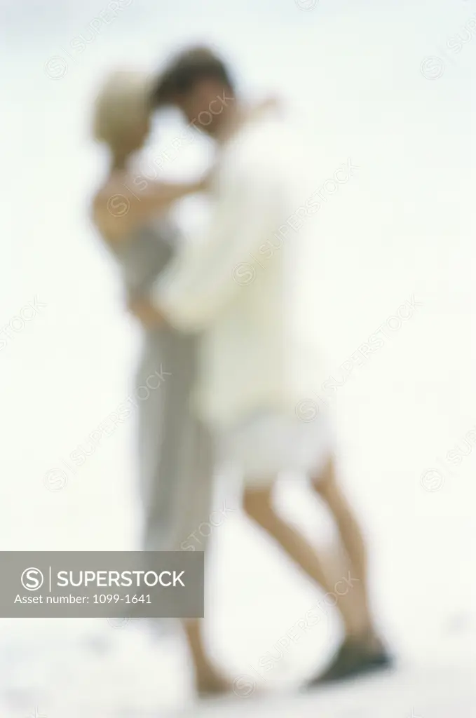 Side profile of a young couple hugging each other