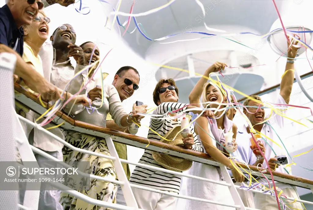 Low angle view of a group of people standing on a cruise ship