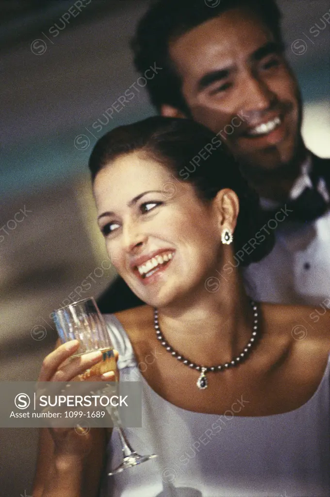 Mid adult couple holding a glass of champagne
