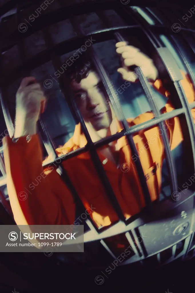 Mid adult man in a prison cell