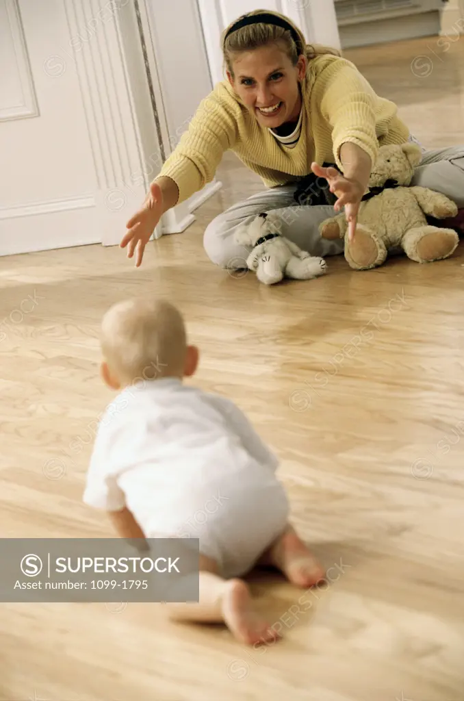 Rear view of a baby boy crawling to his mother