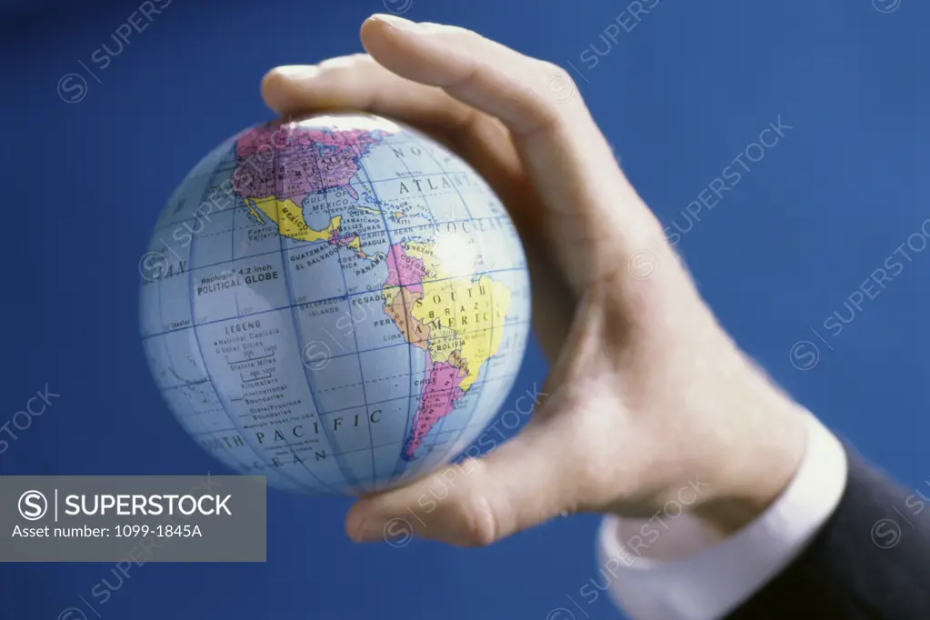 Close-up of a person's hands holding a globe