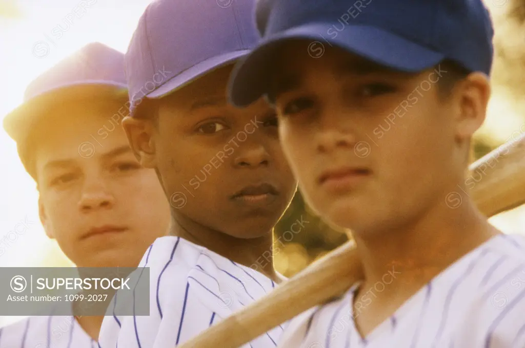 Portrait of three boys on a baseball team