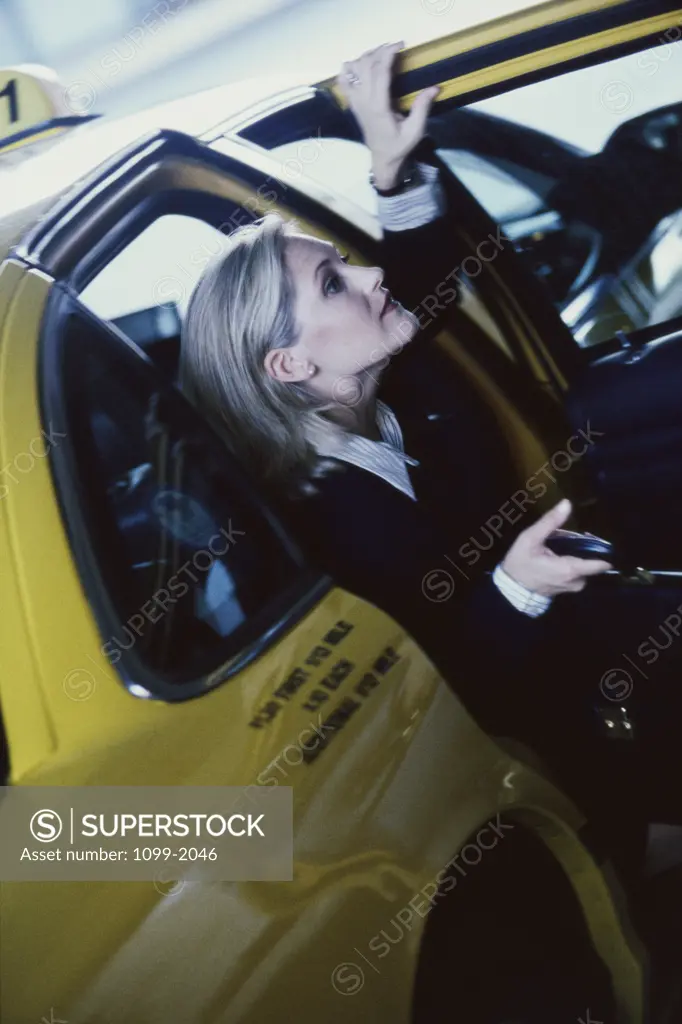Businesswoman exiting a taxi