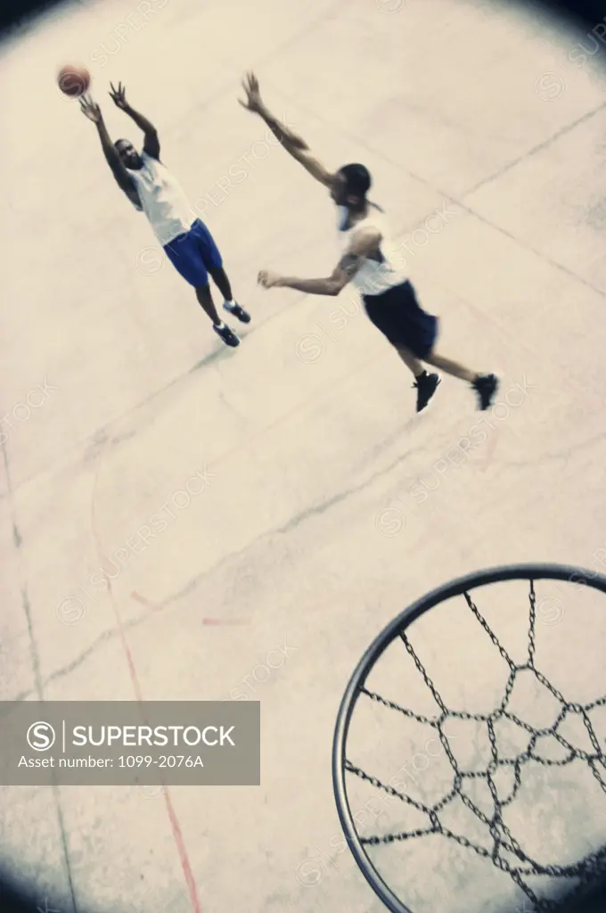 High angle view of two young men playing basketball