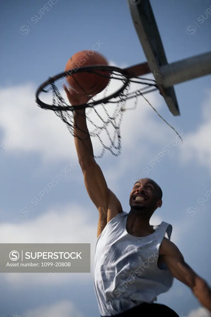 Low angle view of a young man playing basketball