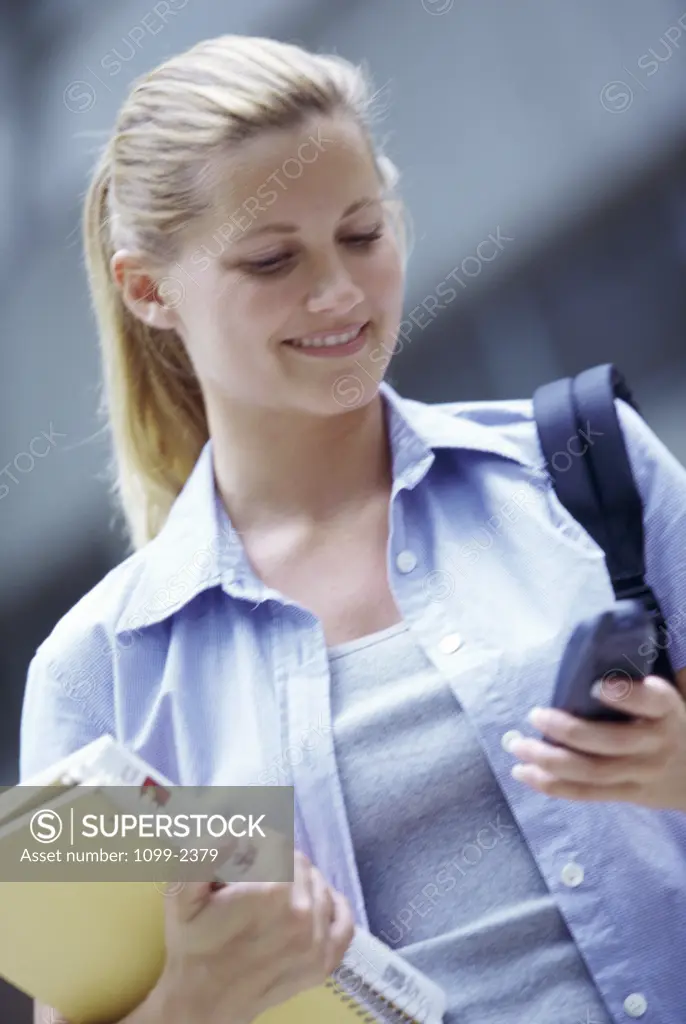 Teenage girl operating a mobile phone