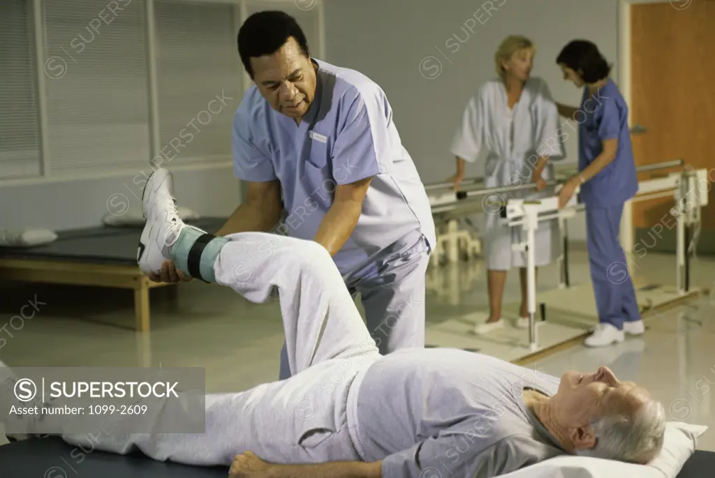 Male doctor helping a mature man