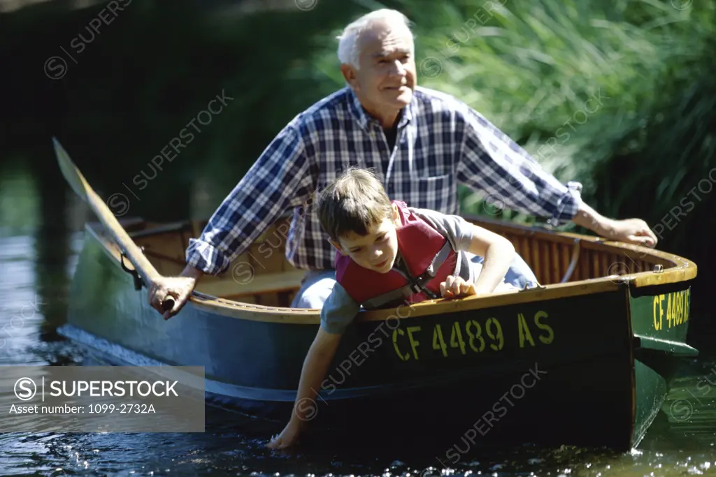 Grandfather with his grandson in a boat