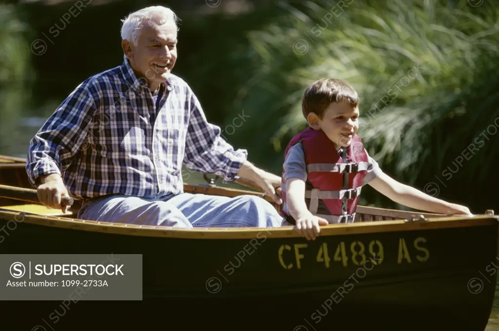 Grandfather with his grandson in a boat