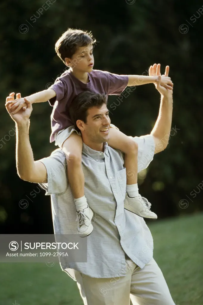 Mid adult man carrying his son on his shoulders