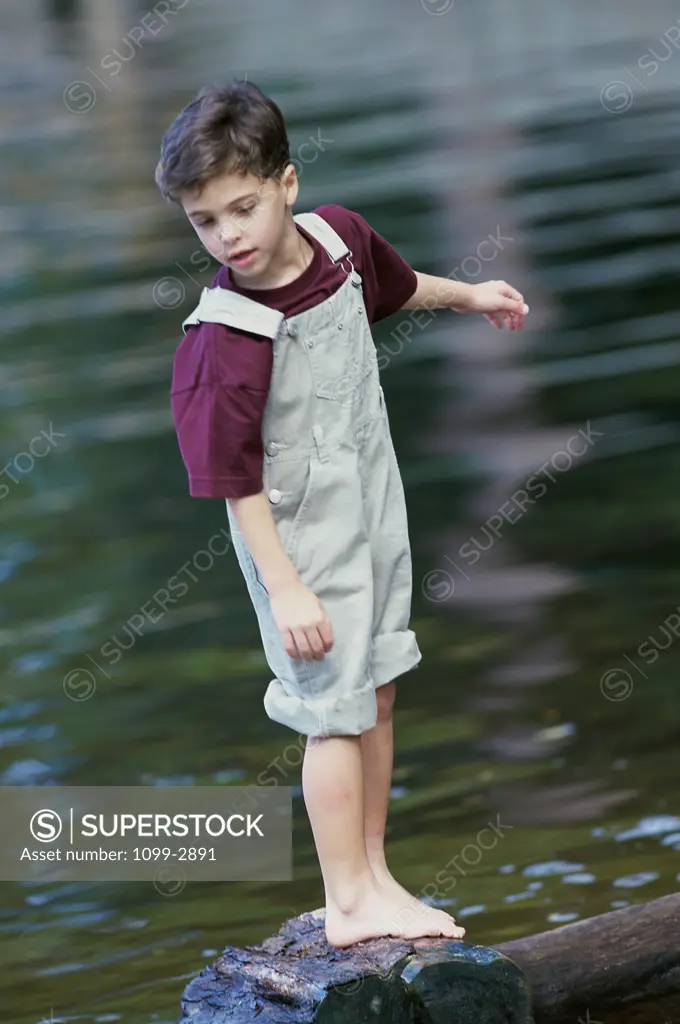 Boy standing on a rock in the river