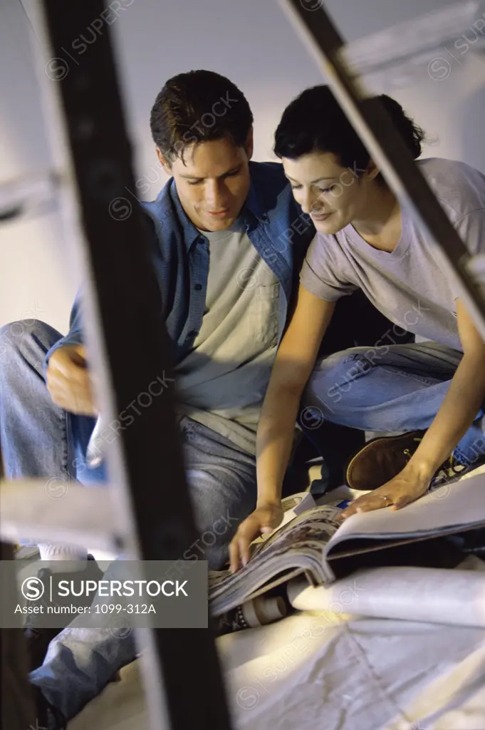 Young couple looking at a catalogue together