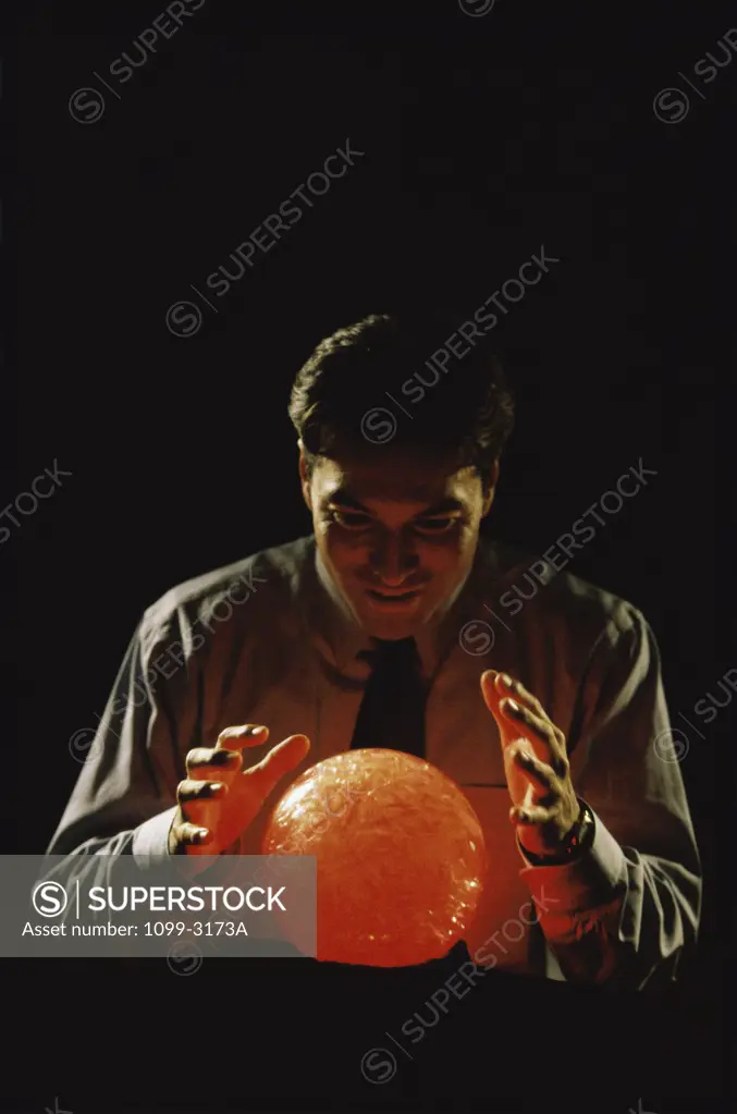 Businessman looking into a crystal ball