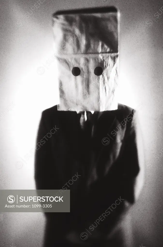 Businessman wearing a paper bag over his head