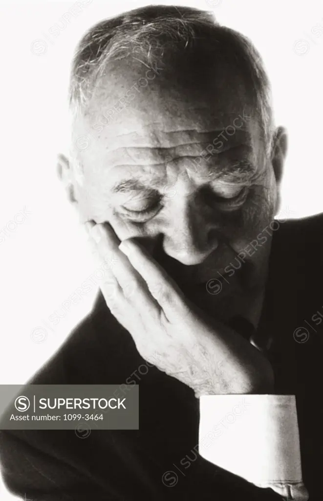 Close-up of a businessman with his eyes closed and his hand on his chin